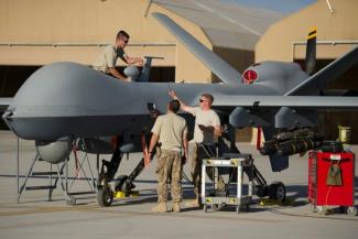 Soldiers doing maintenance work on  a US Air Force Drone in Kandahar, Afghanistan in December 2015.