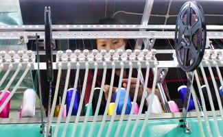 Worker in a polyester sewing production line in China's Guizhou Province.