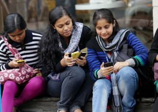 Students with smartphones in Kolkata.