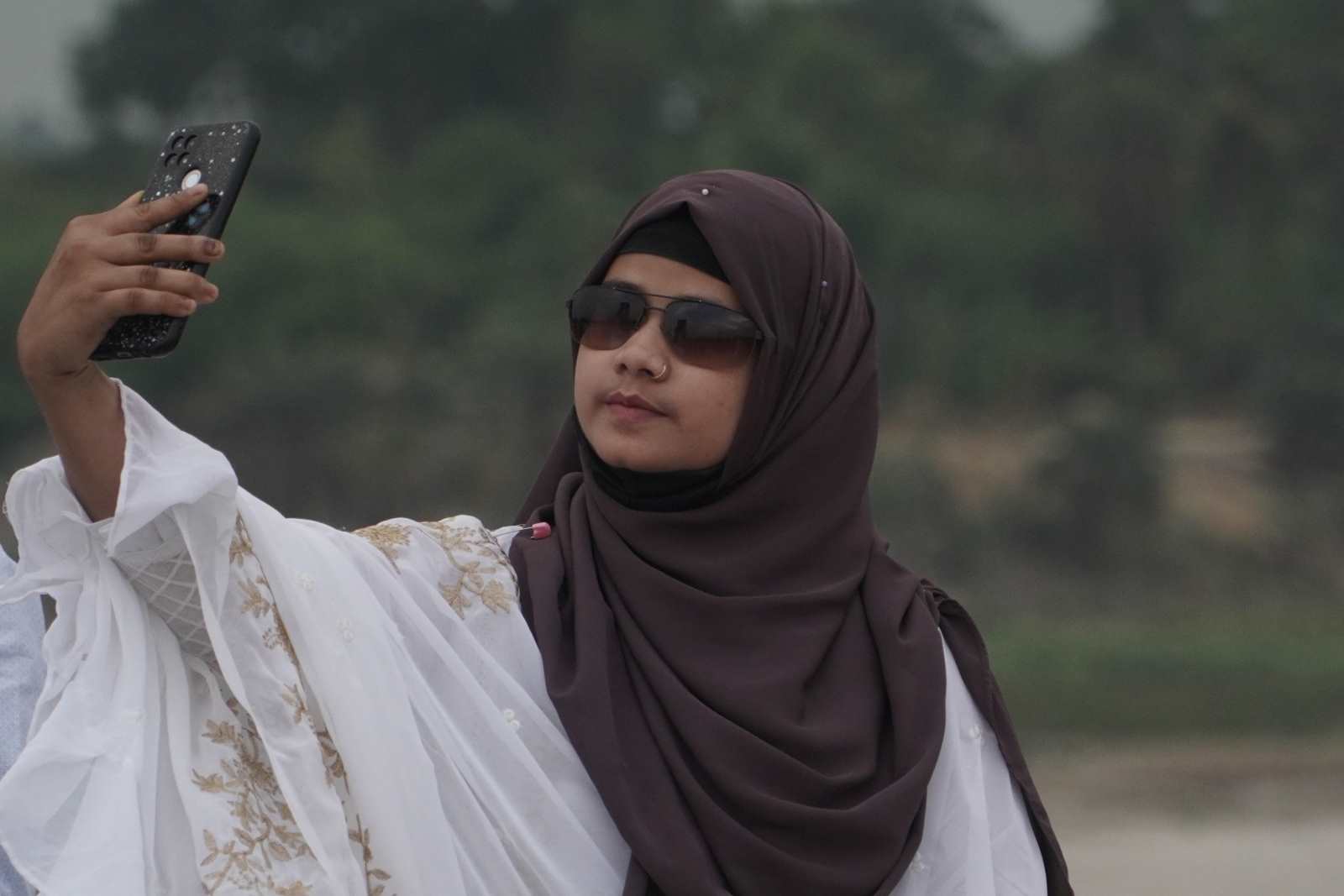 A Bangladeshi teenager taking a selfie. 