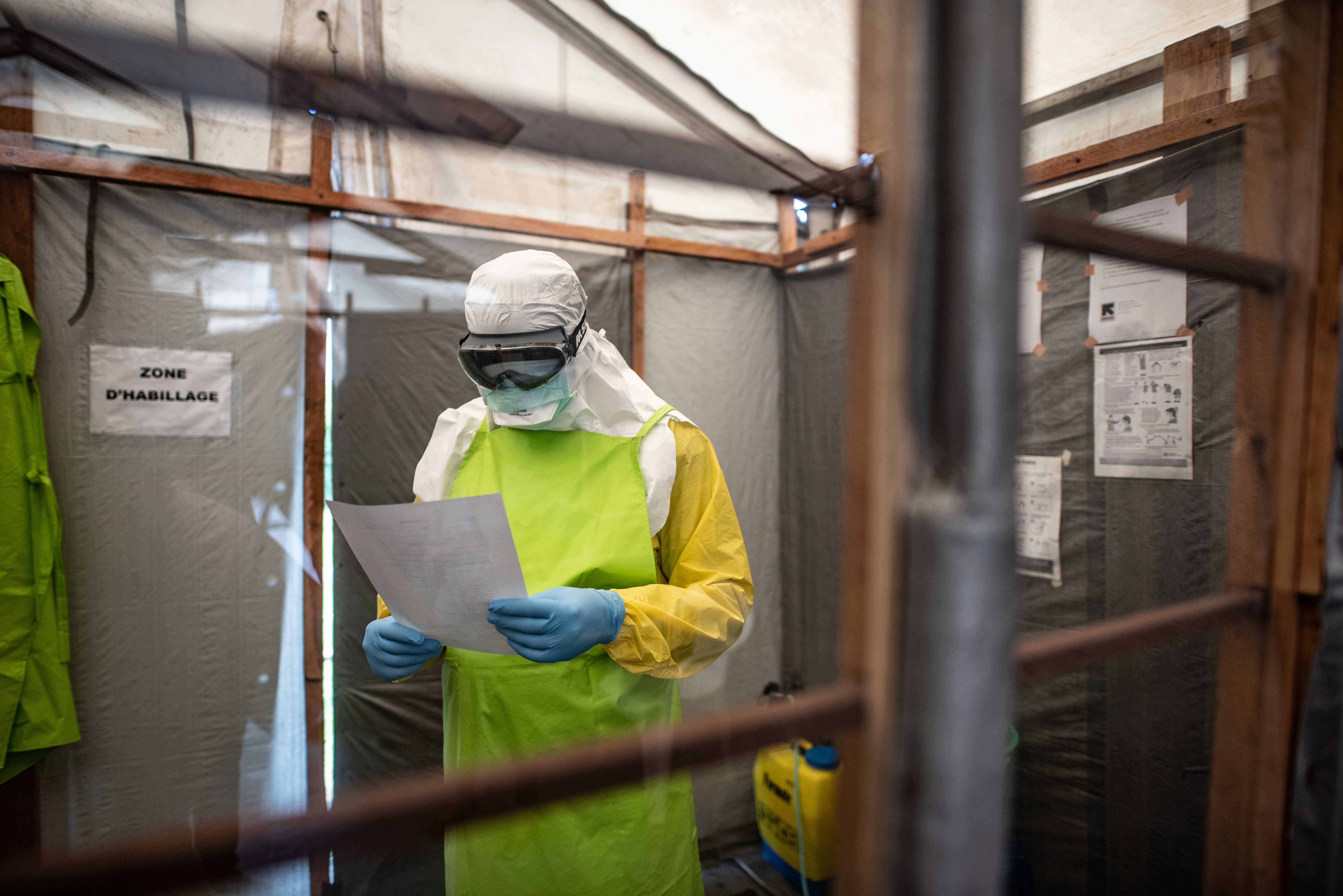 IRC staff member taking off his personal protective equipment during Ebola outbreak in Goma in 2019.