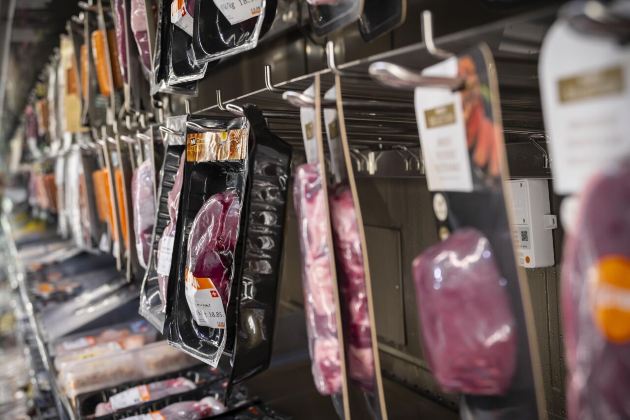 Too much meat, too much plastics, too much consumption: food items in European supermarket. 