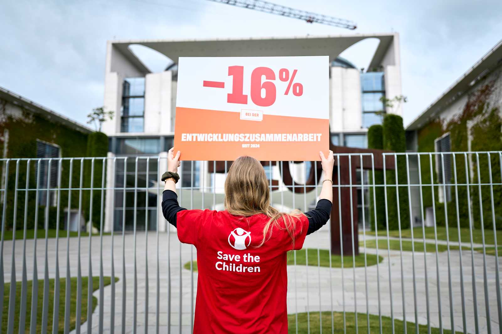 Protest against funding cuts in German development aid in front of the Federal Chancellery in July 2026.