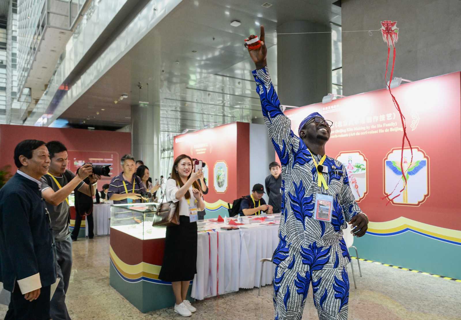 An African journalist flies a kite at the 2024 Summit of the Forum on China-Africa Cooperation (FOCAC) in Beijing.