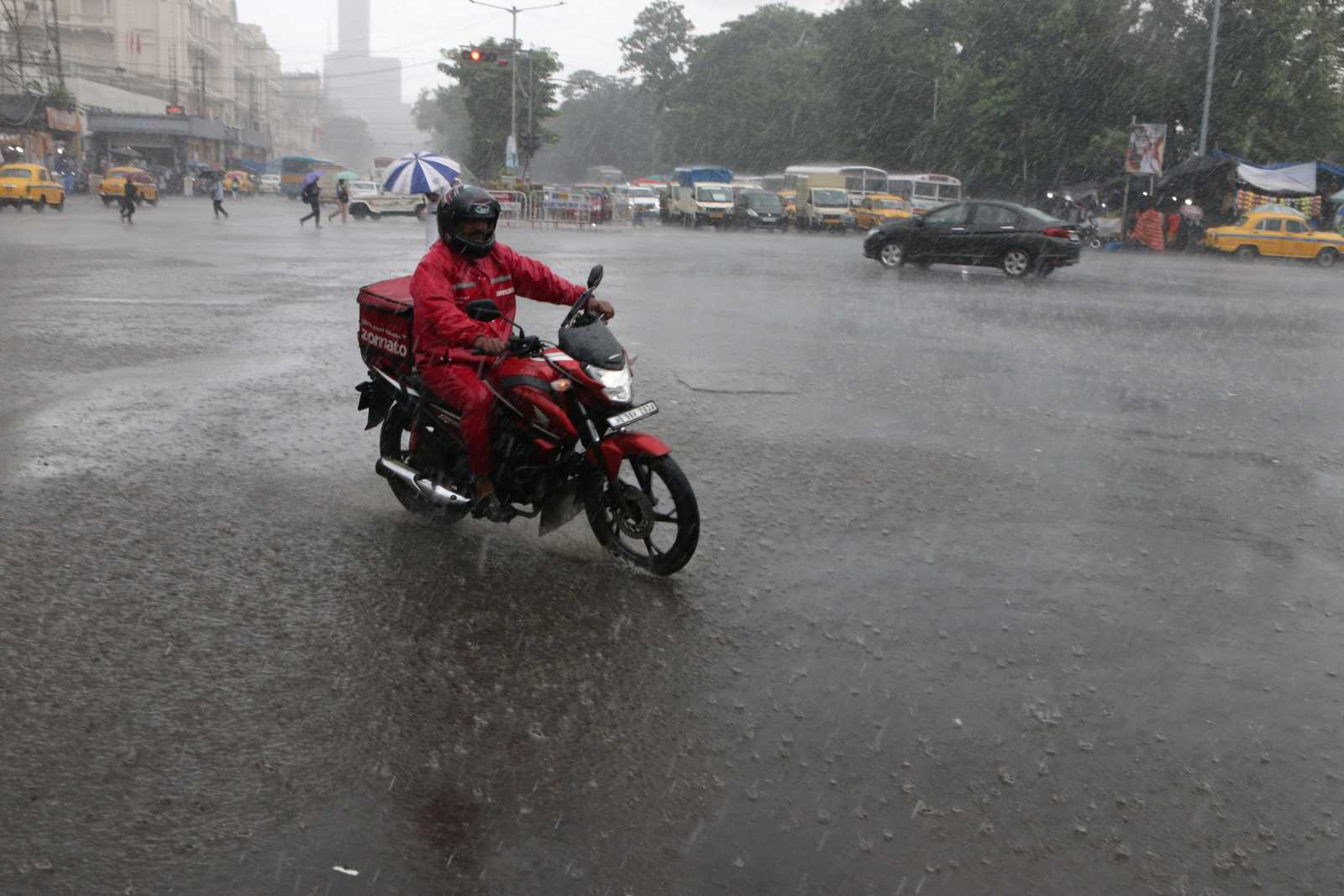 On the job, come rain or shine: a Zomato delivery worker in Kolkata.