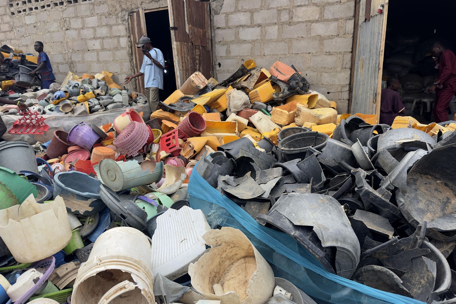 Plastic waste is collected from streets and water channels in Kano, Nigeria, before being processed at a recycling facility.