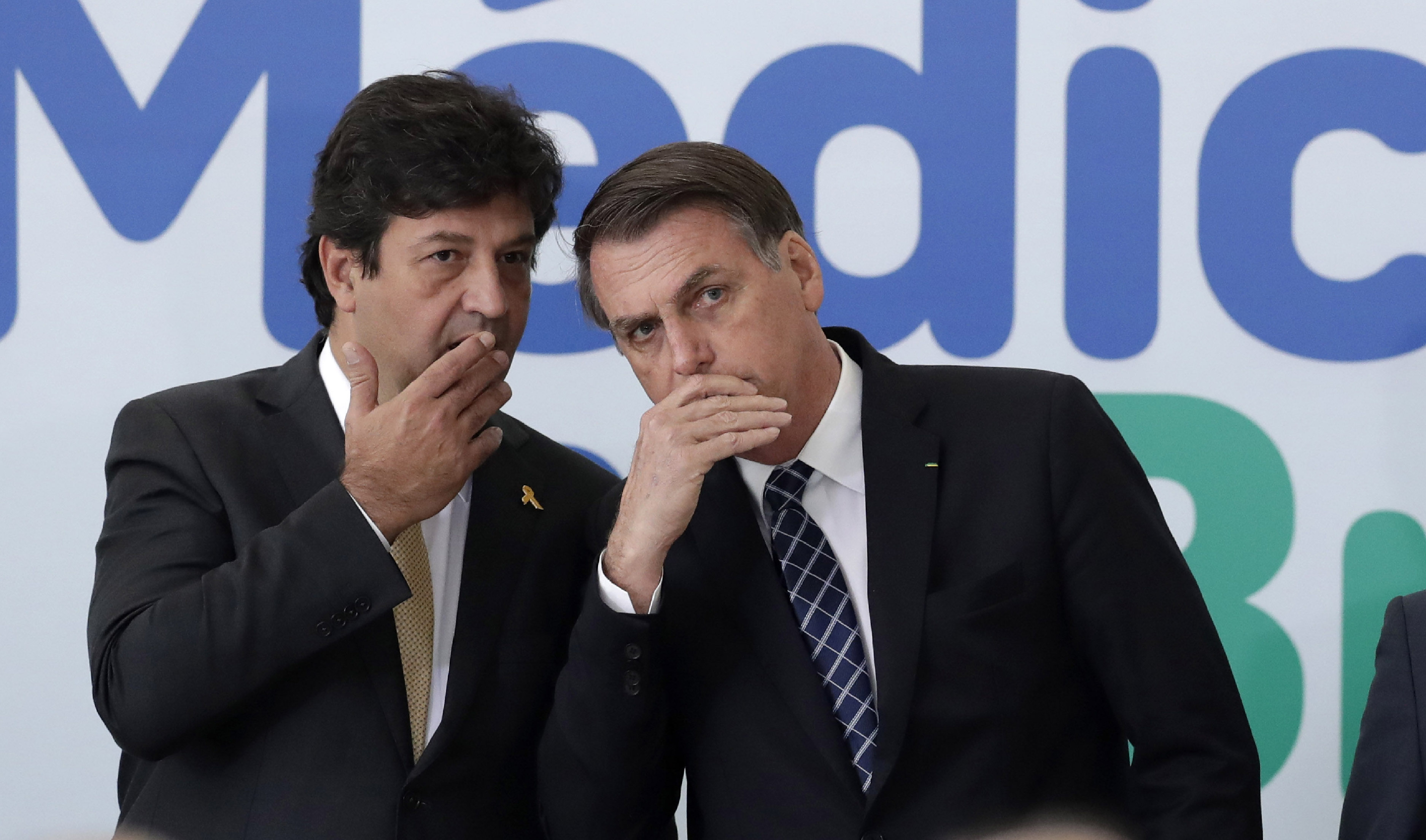 Eraldo Peres/picture-alliance/AP Photo President Bolsonaro (right) grew tired of Health Minister Mandetta’s expert advice. This picture was taken before Covid-19, in summer 2019.
