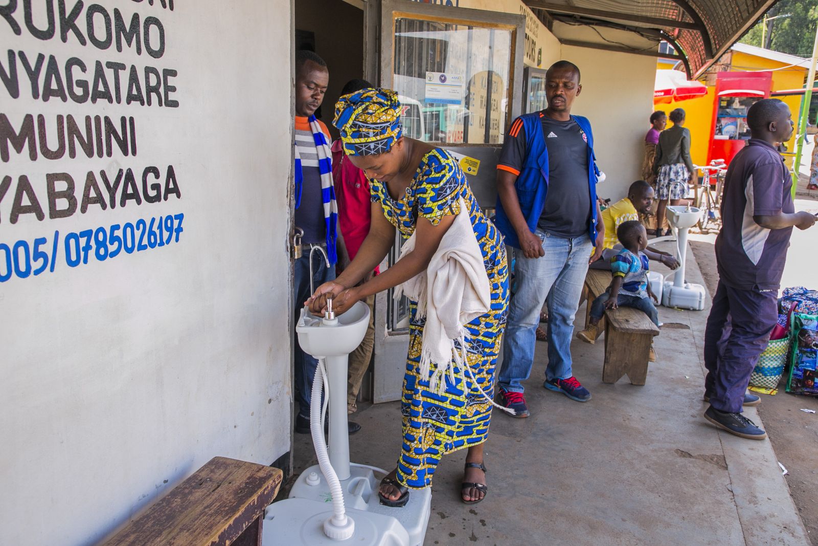 picture-alliance/XinHua A woman washing her hands before entering a bus ticket office in Kigali, Rwanda.