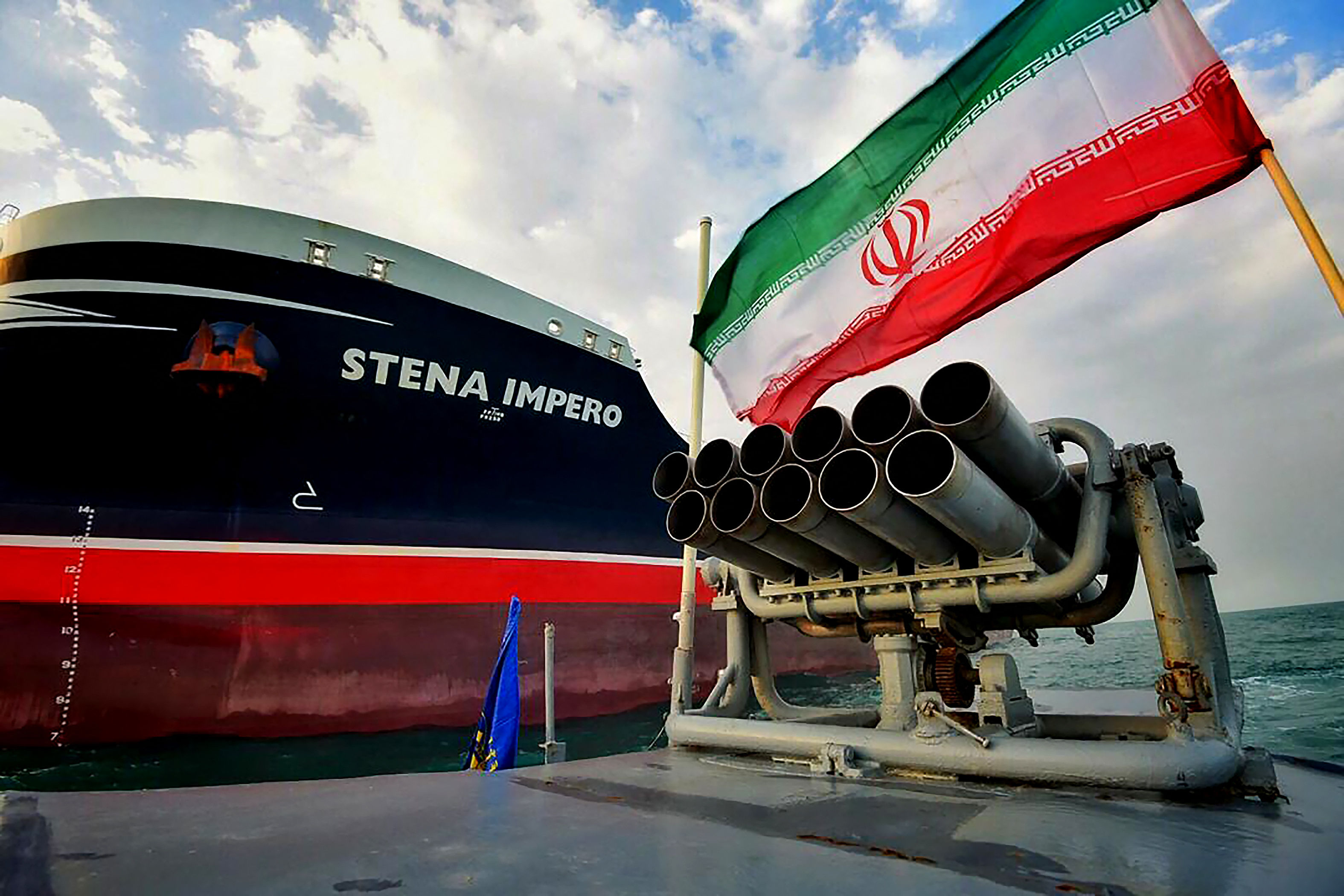 Iran speedboat in front of British-flagged ship.