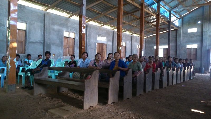 Members of local self-help groups in the Irrawaddy Delta in Myanmar gather in their church to discuss how they can improve their incomes by communal pig farming.