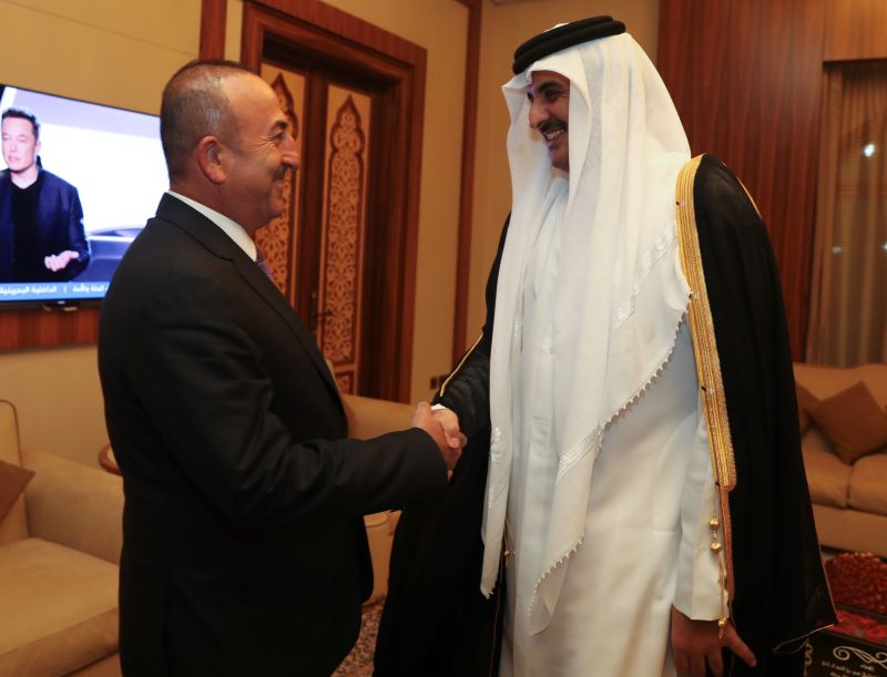 Turkish Foreign Minister Mevlut Cavusoglu in Doha with Emir Tamim bin Hamad Al Thani on 14 June 2017.