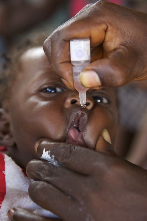 Polio has almost been eradicated: vaccination of a Liberian child.