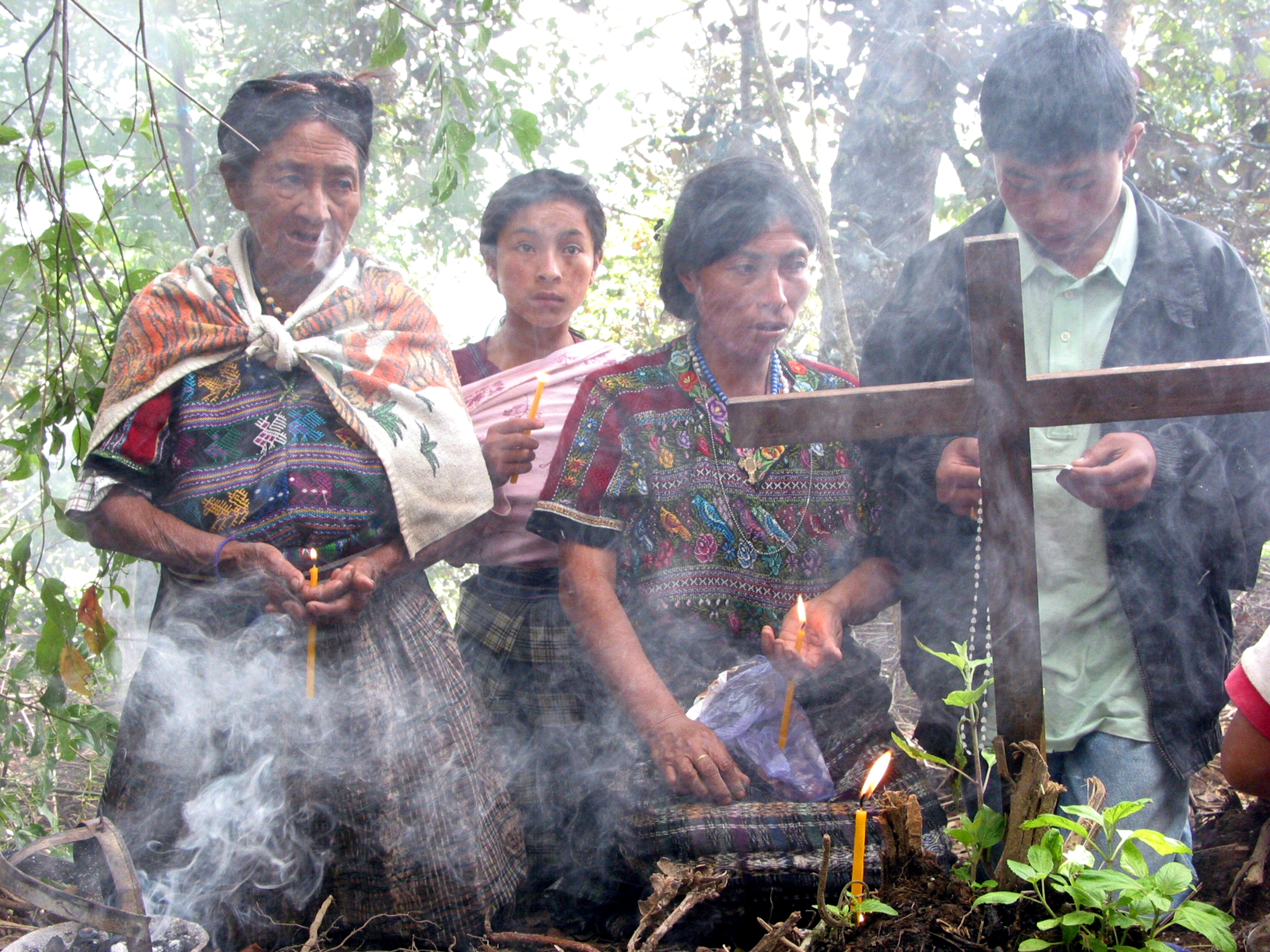 Maya women praying at mass grave at Comalapa, Guatemala.