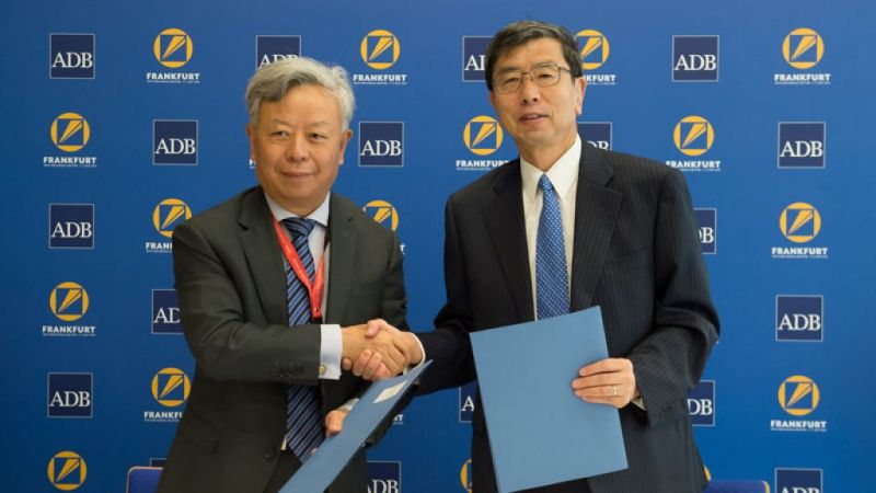 Jin Liqun, AIIB president, with his ADB counterpart, Takehiko Nakao.