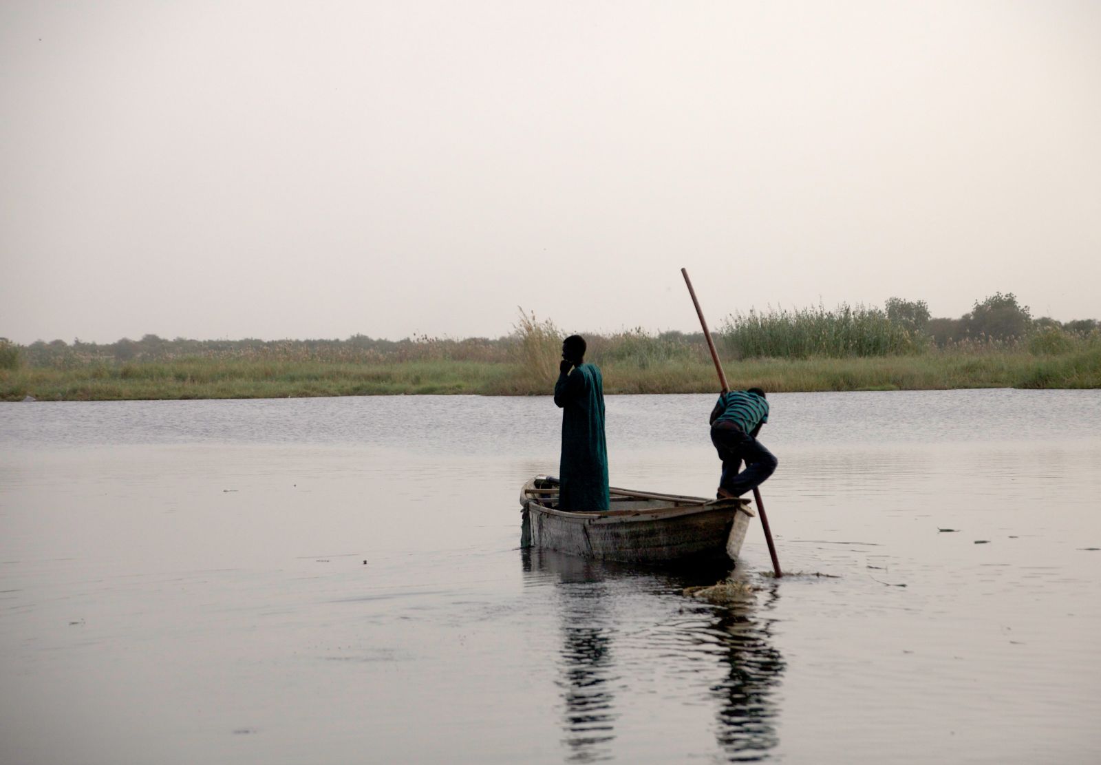A fisher and his son on Lake Chad in Chad.