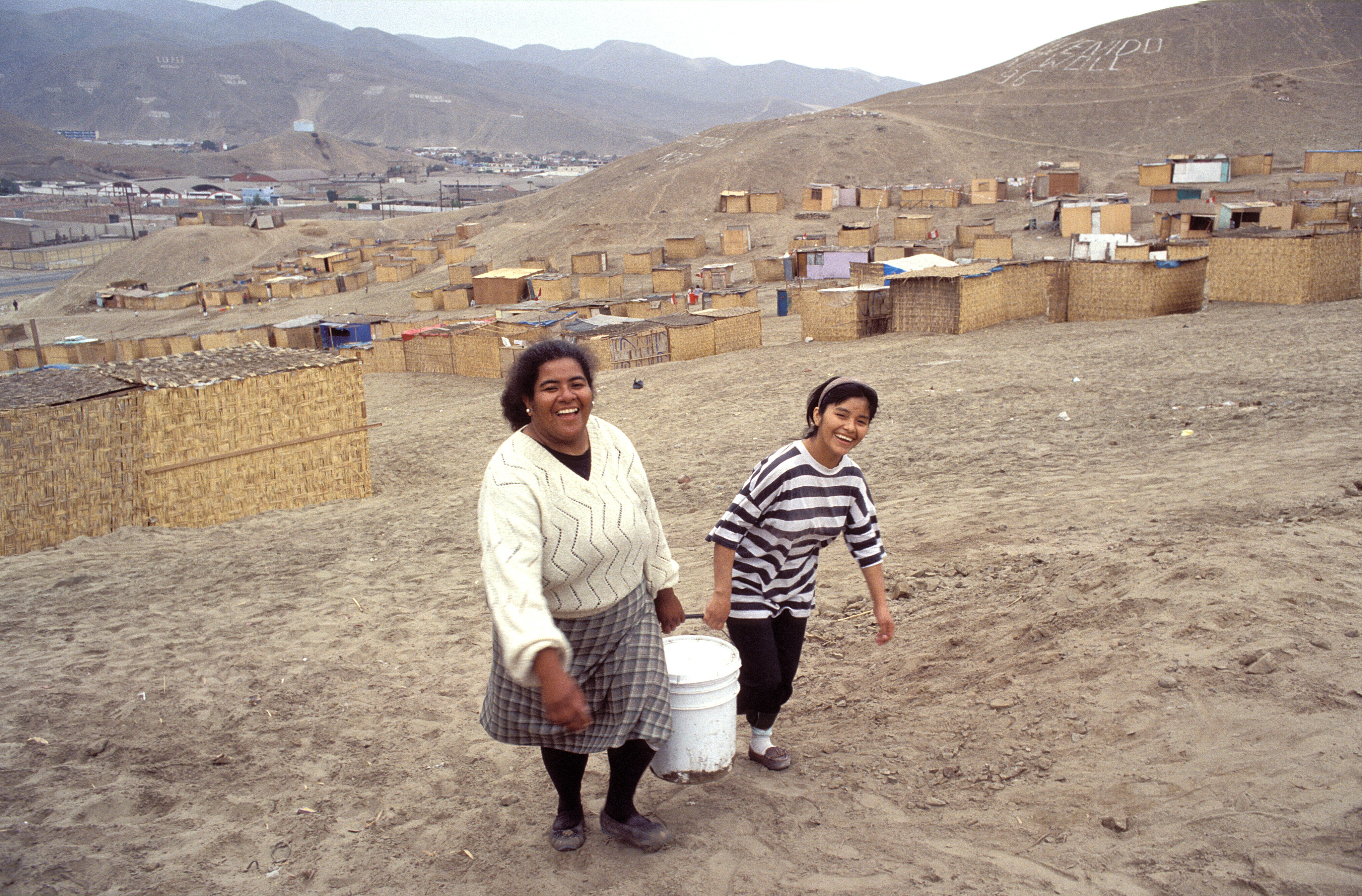 The poor often live far away from the water pipes: women fetching water in the outskirts of Lima.