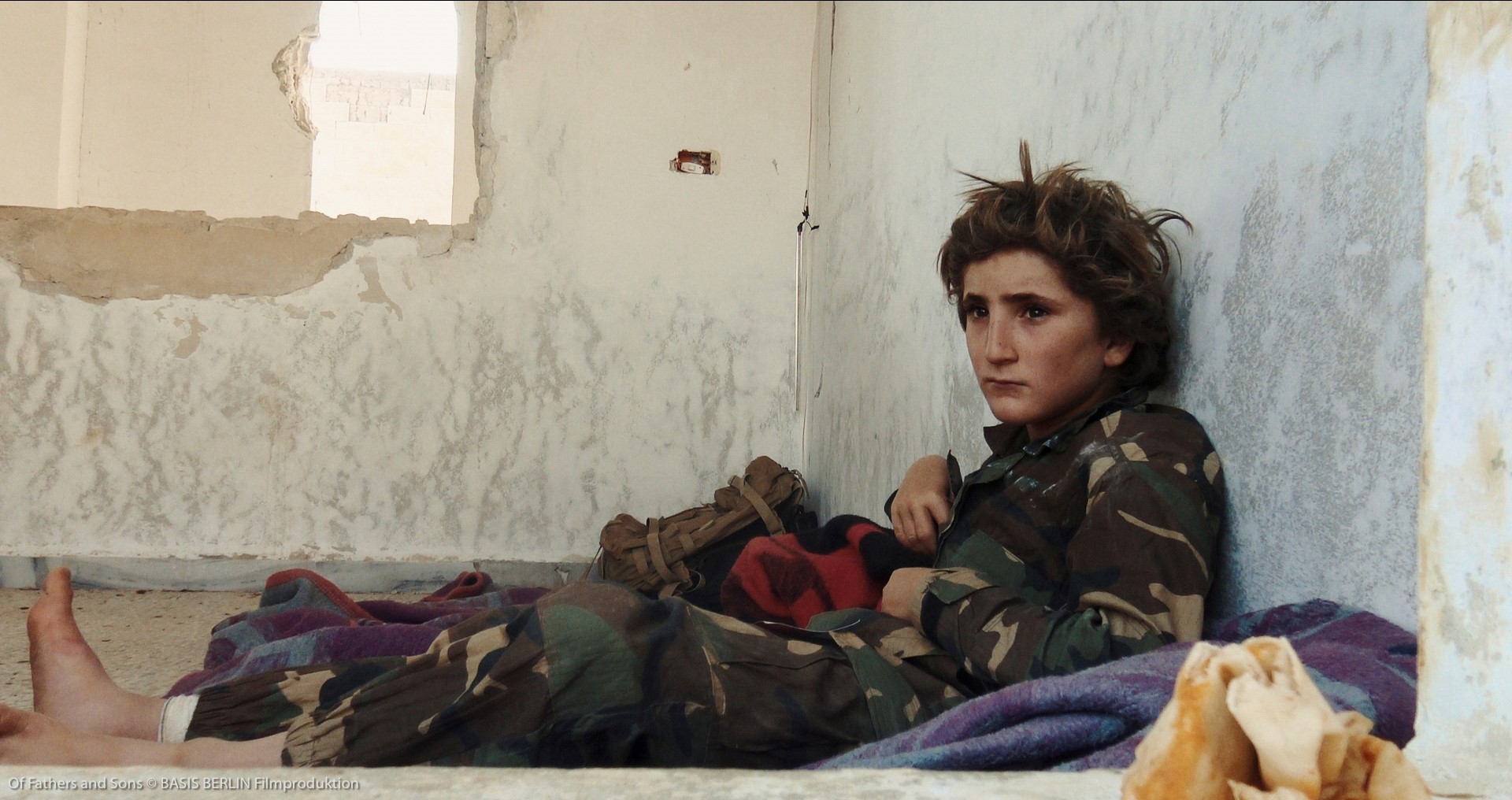 Twelve-year-old Osama in a military camp. He is one of many recruits trained for the “holy war”.