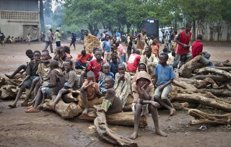 Burundian refugee children sitting on a pile of wood at the Gashora refugee camp in Rwanda.