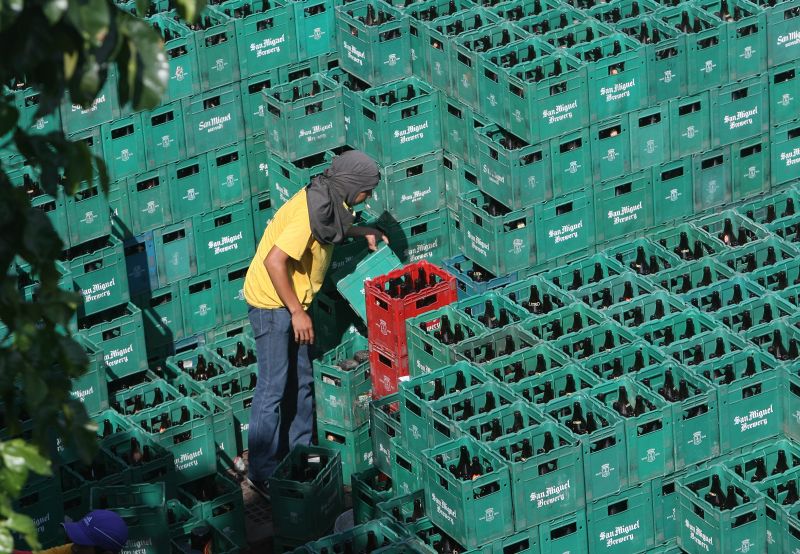A worker with beer crates in Manila.