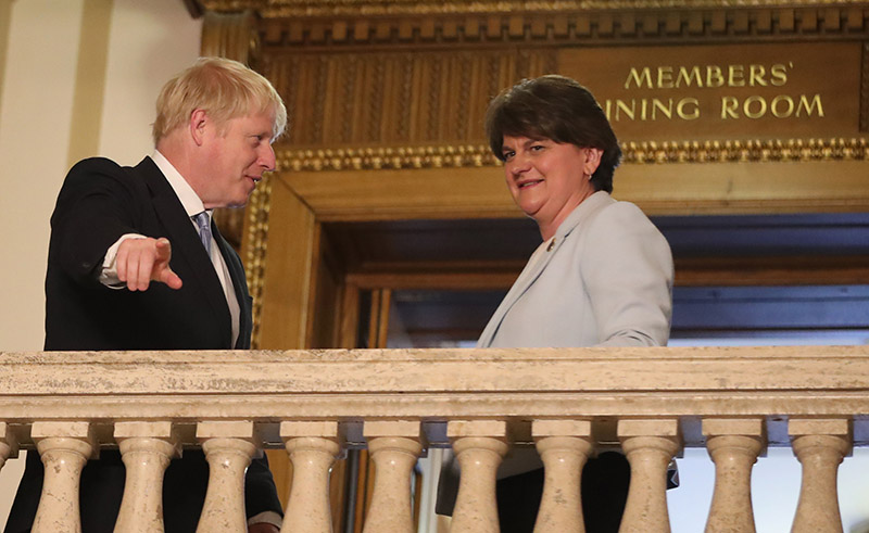 Niall Carson/picture-alliance/empics Disloyal future prime minister Boris Johnson with loyalist DUP leader Arlene Foster in summer 2019. Before rising to power, Johnson insisted there would be no border between Great Britain and Northern Ireland, but his Brexit agreement with the EU would introduce one.