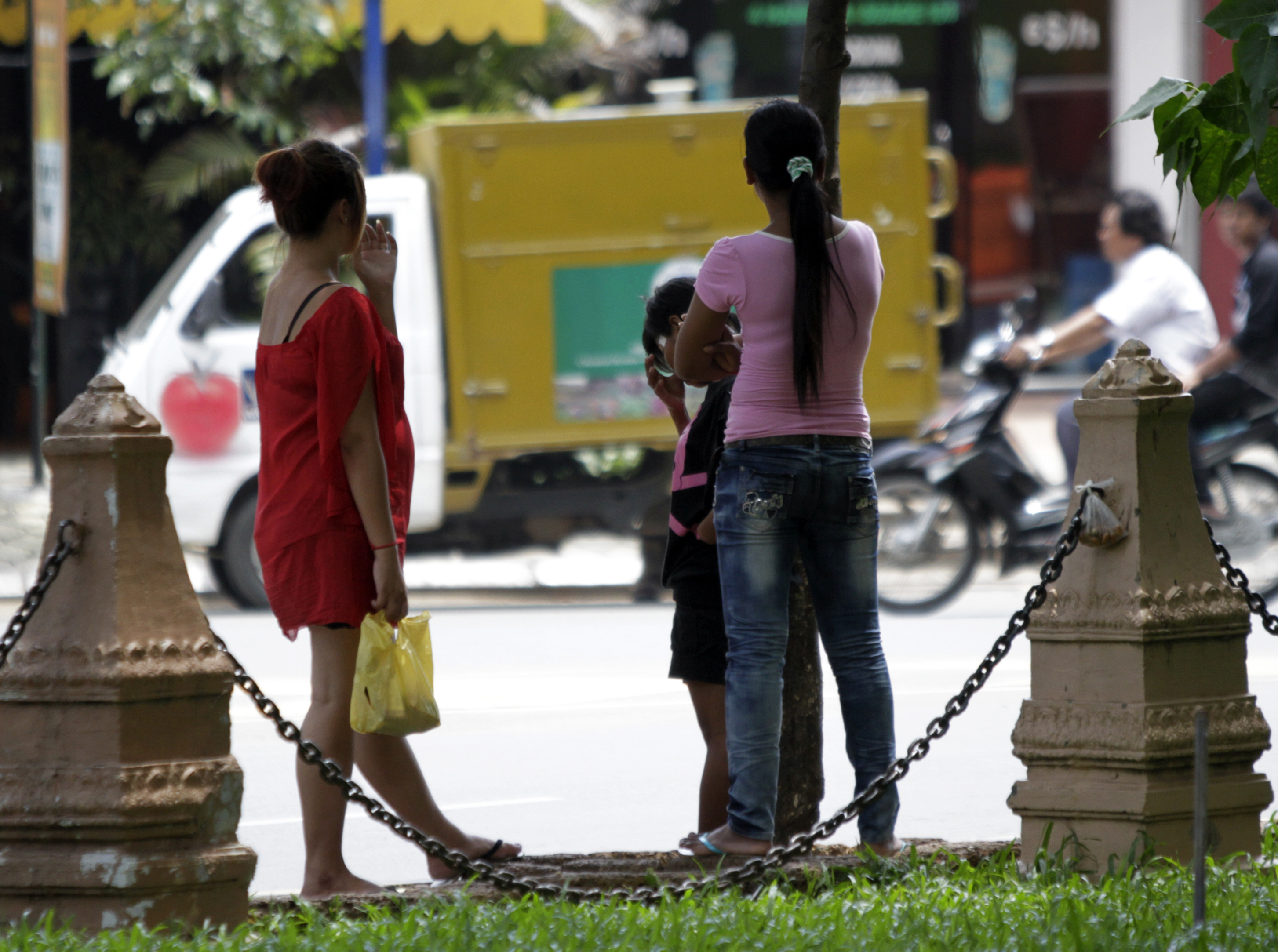Cambodian sex workers wait for customers at  a public park  in Phnom Penh.