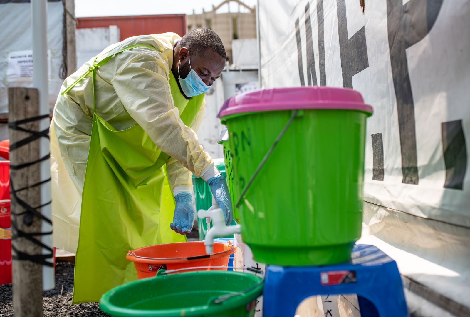 IRC staff member taking off his personal protective equipment during Ebola outbreak in Goma in 2019.