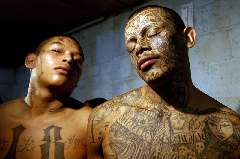 Two members of the gang “Maras 18” pose after their arrest in Guatemala.