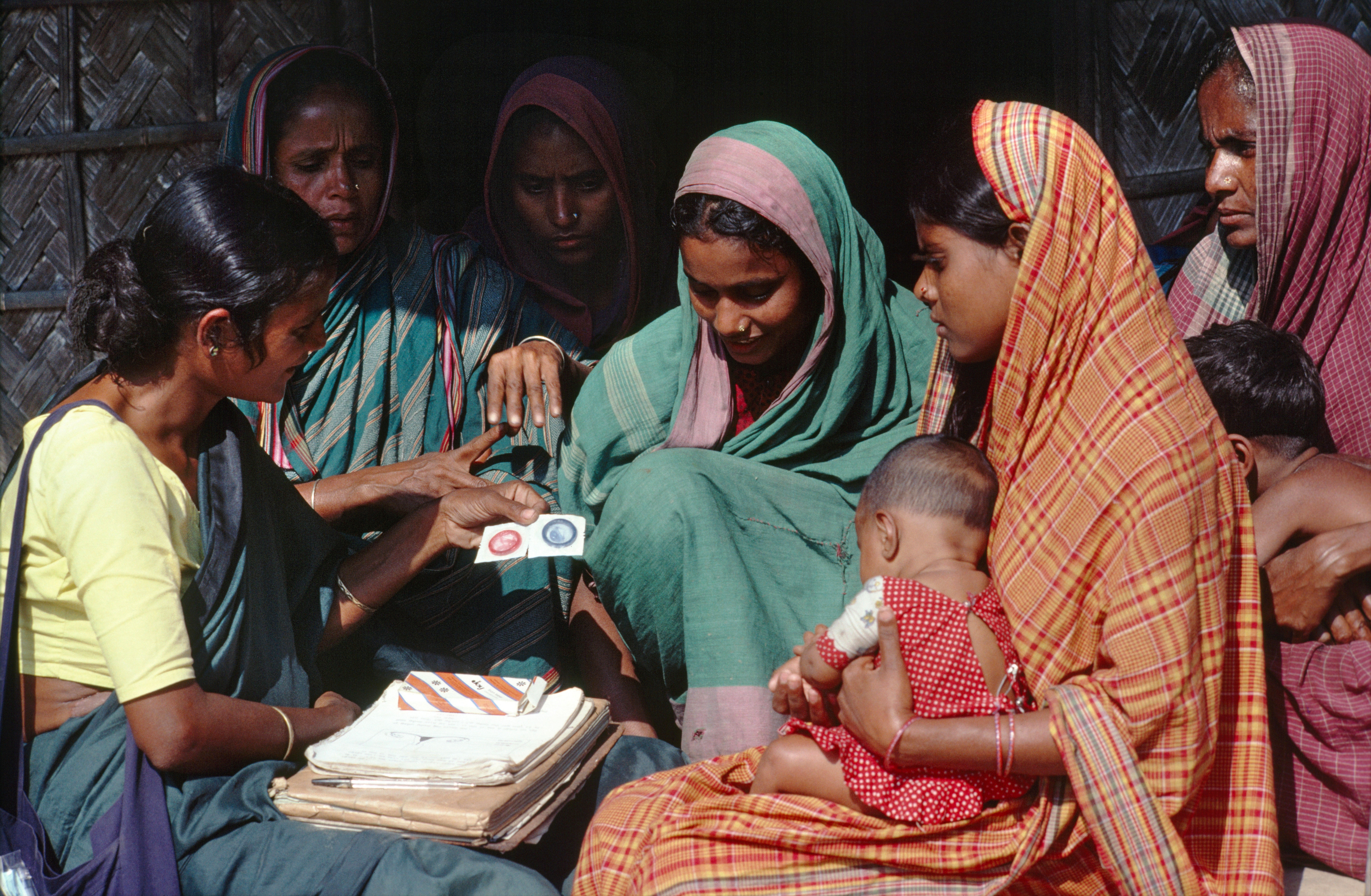 Mark Edwards/Lineair Community health worker promoting condom use in a village in 1995.