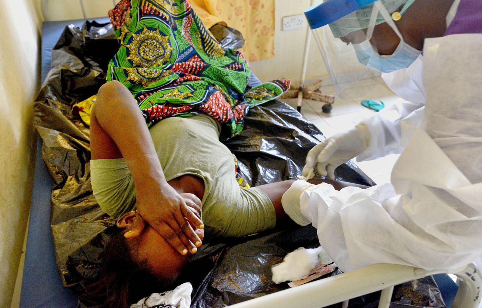 Health worker treating Ebola patient in Sierra Leone in early 2015.