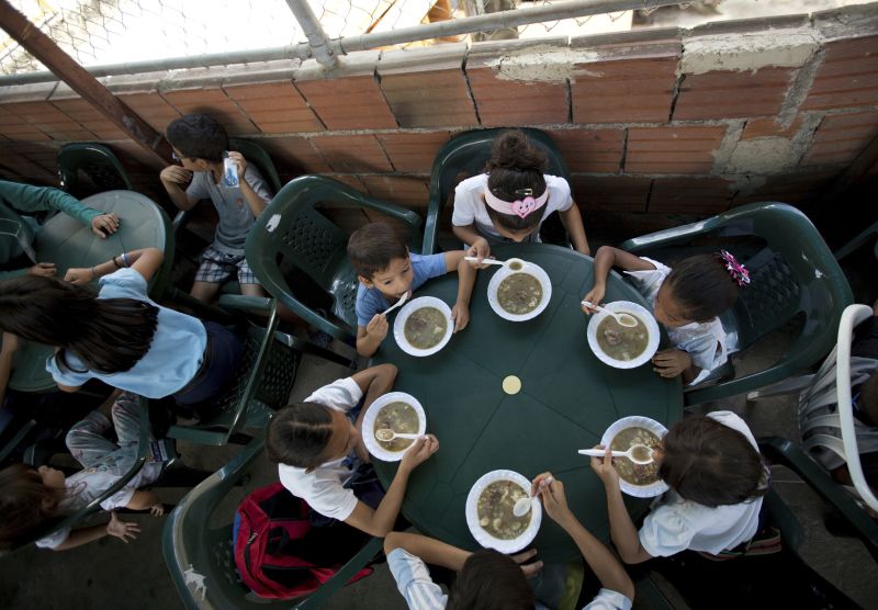 Llano/picture-alliance/AP Images Children receiving a free meal at a soup kitchen in Caracas funded by the opposition.