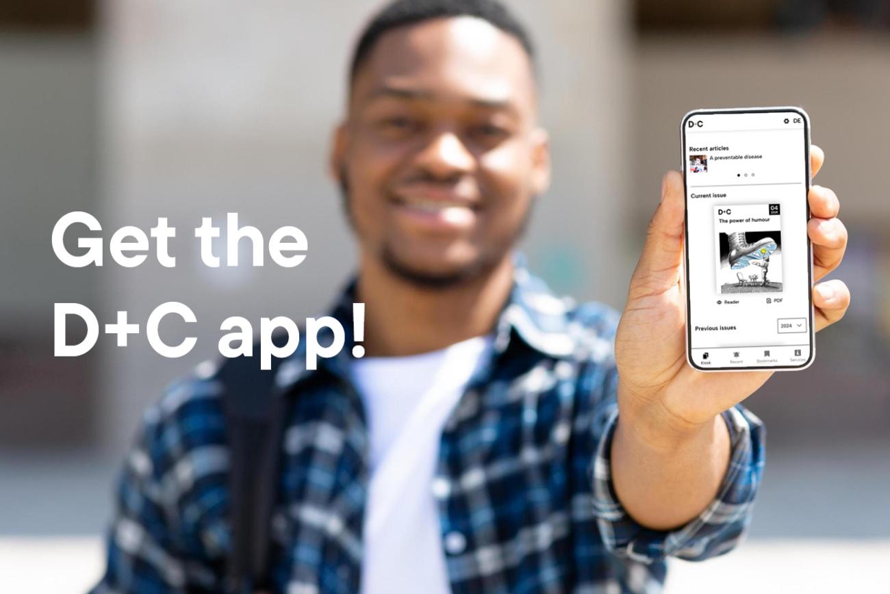 A man holds a smartphone in his left hand with the D+C App on it.