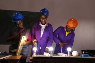 Three participants in the Girls With Tools programme.