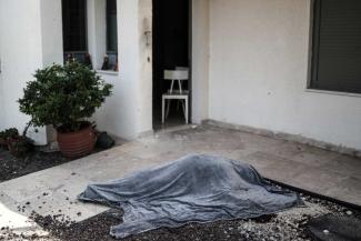 An Israeli resident's shrouded body in Kfar Aza during Hamas pogrom on 7 October.