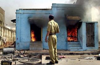 Muslim-owned shops burning in 2002 in Ahmedabad, Gujarat. 