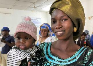 A young mother with her baby in the city of Podor, Senegal. 