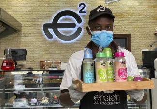 dpa/ASSOCIATED PRESS/Kamran Jebreili Restaurant jobs are sought after among African migrants: a waiter at a café in Dubai.