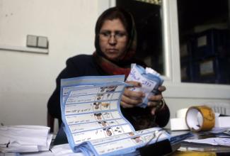 Election assistant counting votes in Kabul.