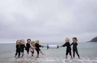 Mask-wearing activists demand more consequential Covid-19 action from G7 in Cornwall.