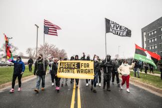 Protesters march in the Minneapolis suburb where, on 11 April 2021, a police officer killed Daunte Wright, a young Black man.