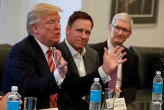 Peter Thiel (centre) with Donald Trump and Tim Cook of Apple at the White House in 2016.