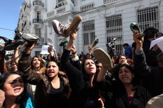 Tunisian protesters hold up their shoes in a gesture of contempt for Sihem Badi, the minister for women’s affairs.