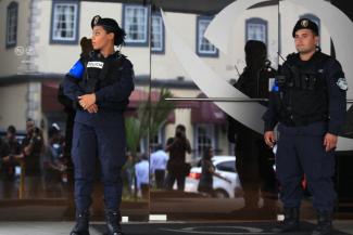 Police officers guard the entrance of a bank in Panama accused of money laundering by US officials.