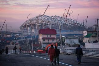 Labour migrants on their way to the stadium building site in 2012