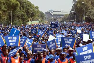Supporters of the opposition Democratic Alliance party march toward the Constitutional Court in Johannesburg demanding the resignation of President Jacob Zuma on 15 April.