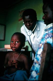 A doctor examining a child at a hospital on the outskirts of Cotonou.