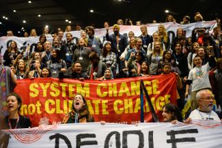 Demanding system change to stop global warming: rally at the UN climate conference in Katowice.