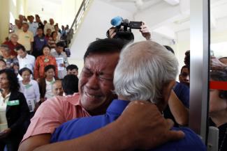 Surviving Khmer-Rouge victims embrace after the announcement of the verdicts.