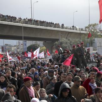 Democracy could yet prevail: people attending the funeral of Chokri Belaid, the assassinated trade-union leader, earlier this year.