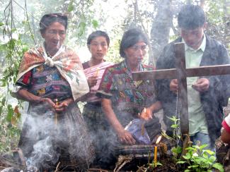 Maya women praying at mass grave at Comalapa, Guatemala.