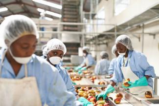 Workers at a Kenyan juice-producing company that has taken DEG loans.